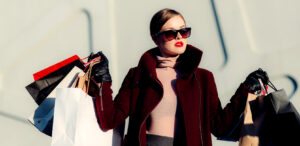 What does Customer Centricity mean in 2023? Woman shopper carrying designer shopping bags